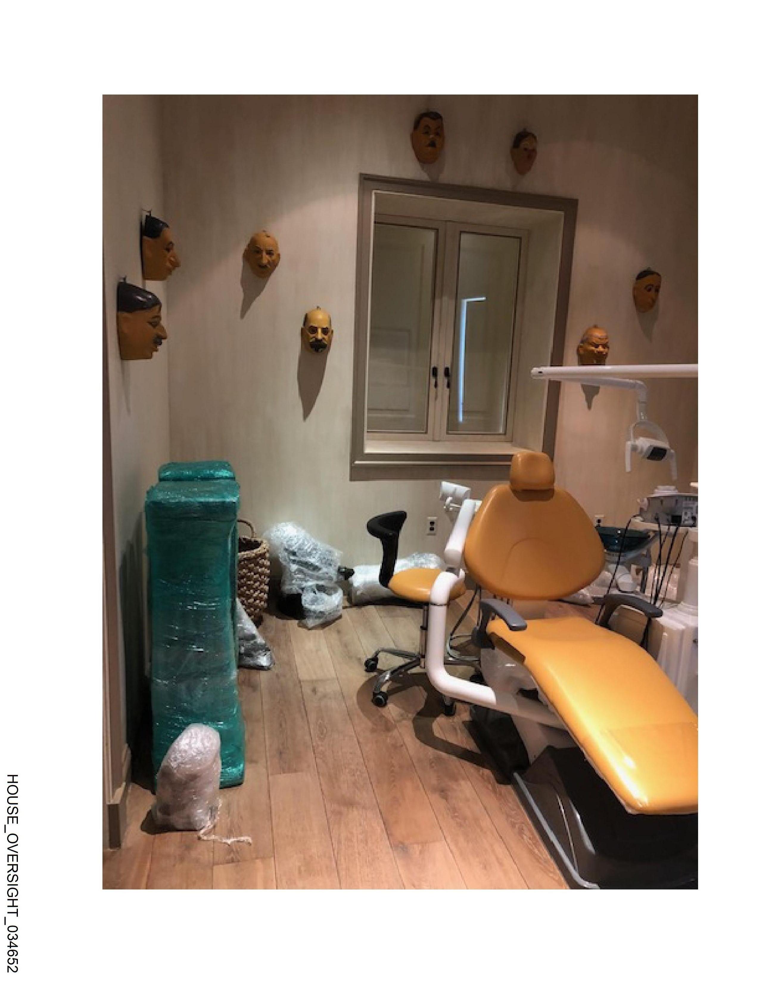 Dental chair with masks on wall